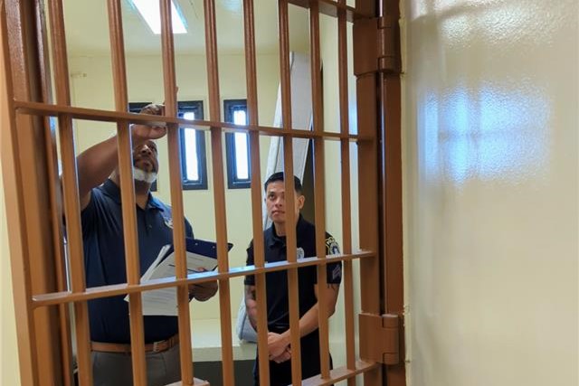 Man inspecting jail cells